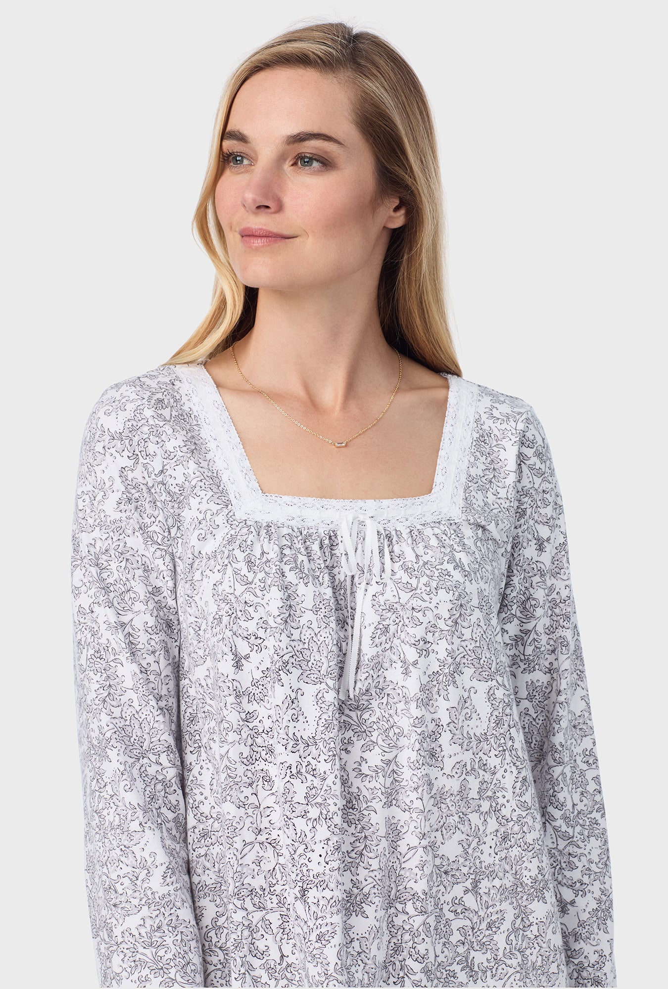 A lady wearing ballet nightgown with grey paisley print