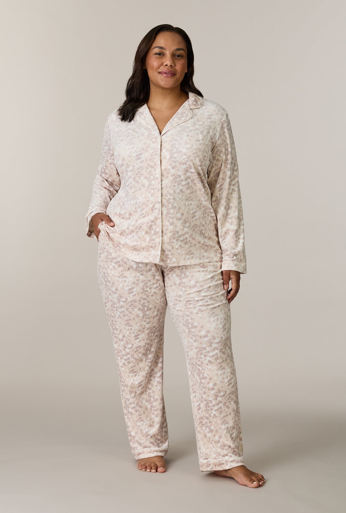A lady wearing plus size Soft Spots Stretch Velour Notch Collar Long Pajama Set