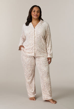 A lady wearing plus size Soft Spots Stretch Velour Notch Collar Long Pajama Set