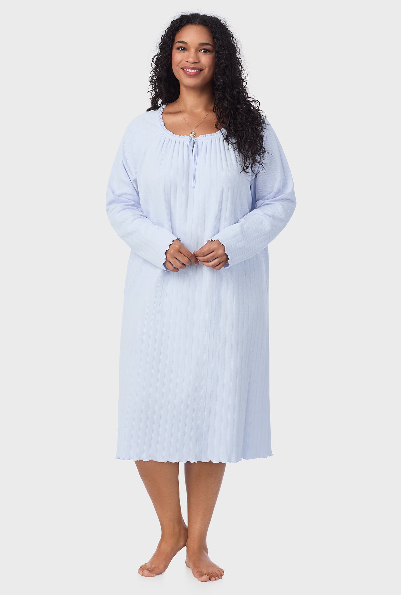 A lady wearing blue long sleeve cotton pointelle waltz plus nightgown.