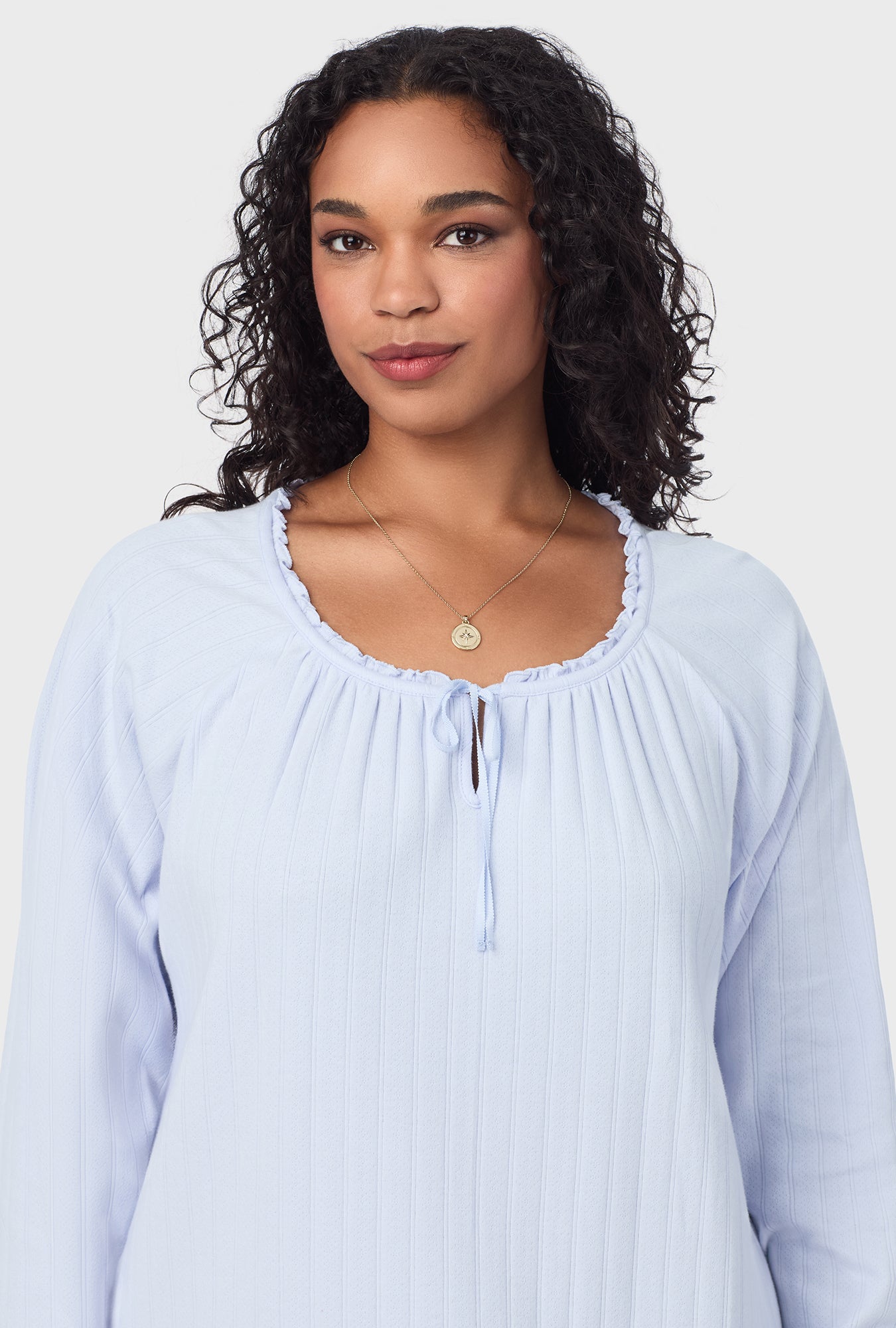 A lady wearing blue long sleeve cotton pointelle waltz plus nightgown.