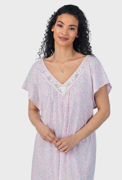 A lady wearing pink short sleeve cotton ballet plus size nightgown with tulip field print.