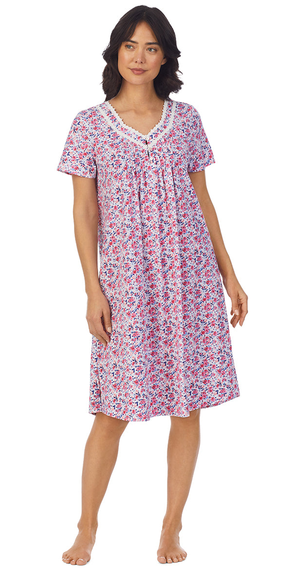 A lady wearing a short sleeve waltz nightgown with pink floral pattern.