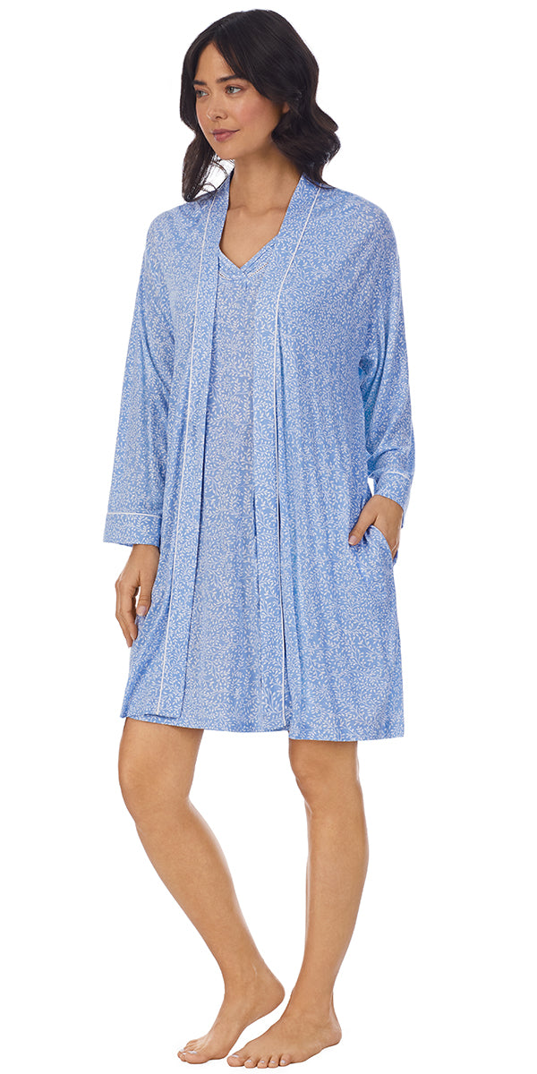 A lady wearing a blue long sleeve short robe with white vine pattern.
