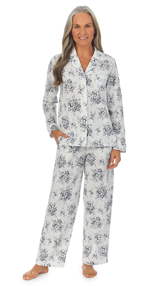 A lady wearing a long sleeve pajama set with winter blossom pattern.