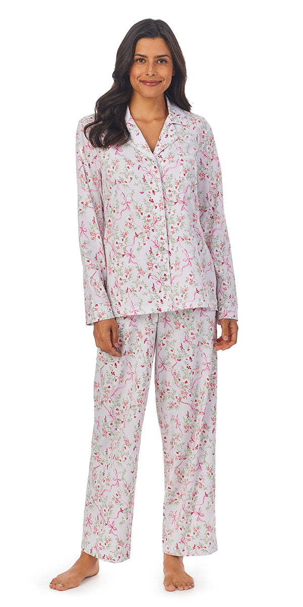 A lady wearing a grey long sleeve pajama set with ribbon floral pattern.