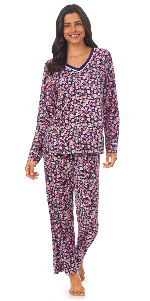 A lady wearing a long sleeve pajama set with pink rose pattern.