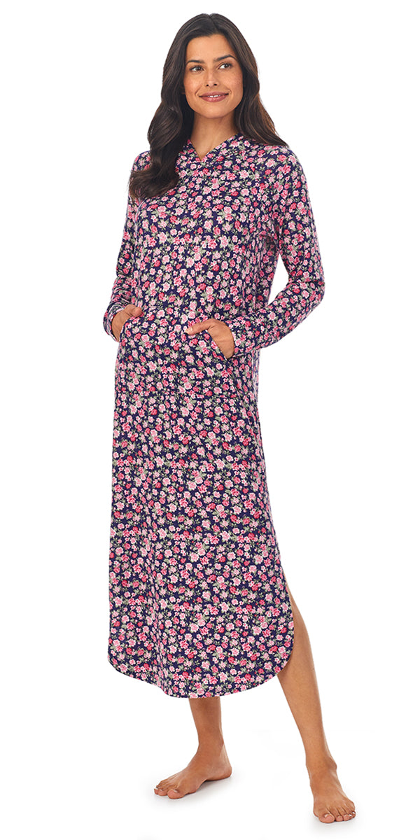 A lady wearing a long sleeve long nightshirt with  pink floral pattern.